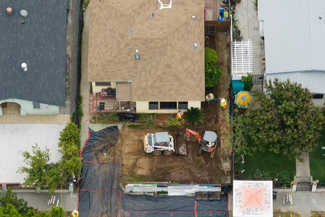 Aerial view of a house in the Boyle Heights neighborhood of Los Angeles gets cleaned of lead contamination from the shuttered Exide plant on Friday, June 9, 2023.
